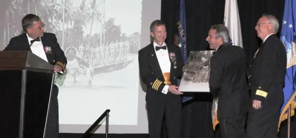 Rear Admiral Charles Williams being presented with award
